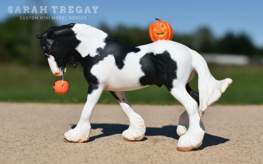 CM Breyer by Sarah Tregay, a Custom Mini/ Stablemate Model Horse to black and white pinto drum horse with purble bow and jack-o-lantern, a Halloween decorator Breyer Stablmate