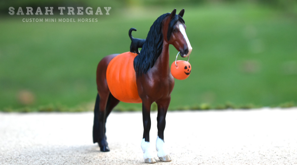 Halloween Model Horse Bay / Clydesdale x Frieisan Stallion, Trick-or-treat, Custom Breyer Stablemate by Sarah Tregay, a Custom Mini/ Stablemate Model Horse with cat and a pumpkin belly Jack-o-lantern