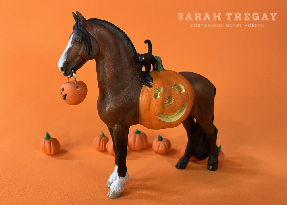 Halloween Model Horse Bay / Clydesdale x Frieisan Stallion, Trick-or-treat, Custom Breyer Stablemate by Sarah Tregay, a Custom Mini/ Stablemate Model Horse with cat and a pumpkin belly Jack-o-lantern